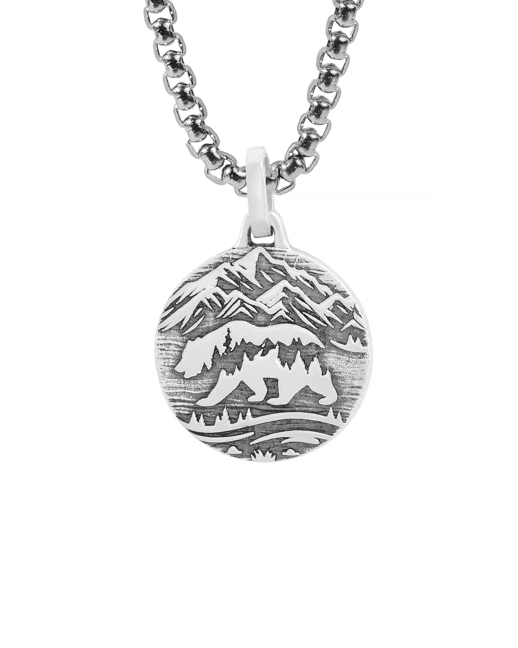 round silver pendant necklace with bear and mountains engraving.