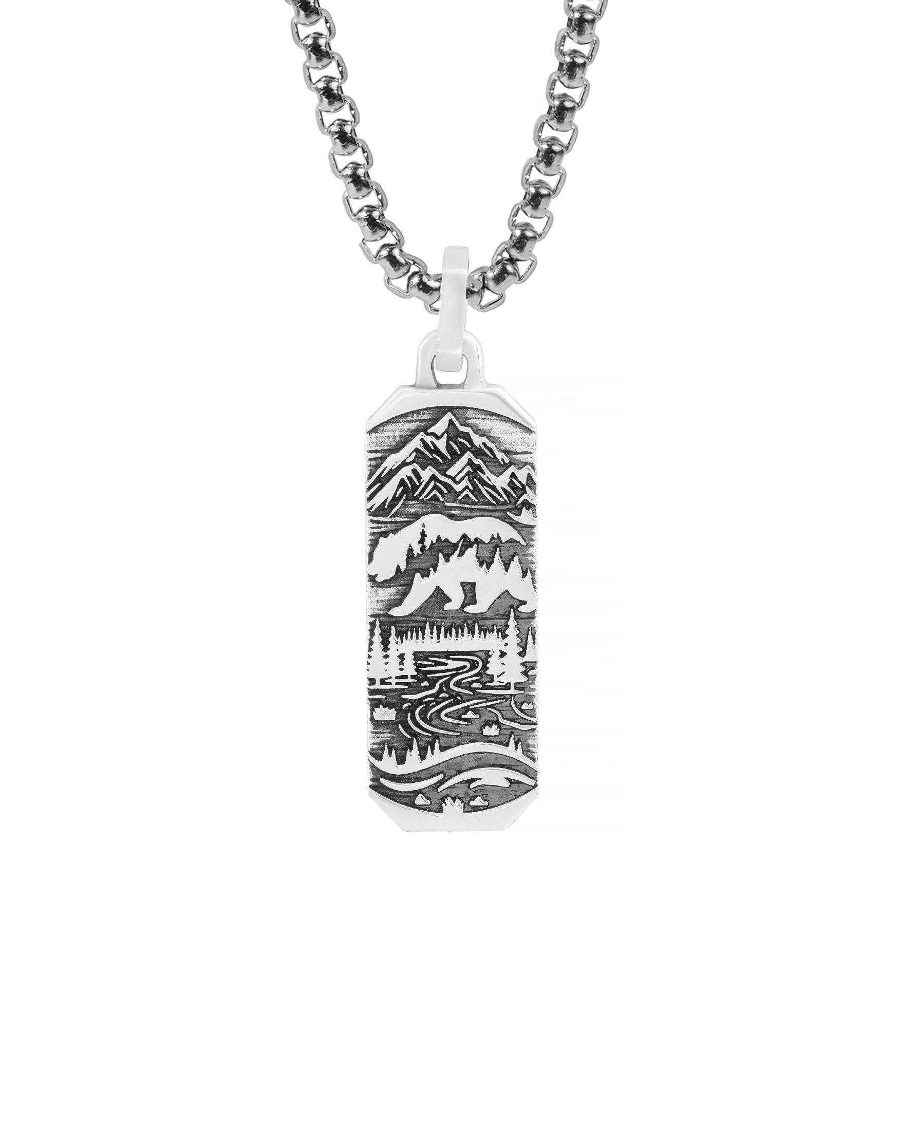 nature inspired silver bar necklace pendant with landscape of mountains, bear and a road in spruce forest.