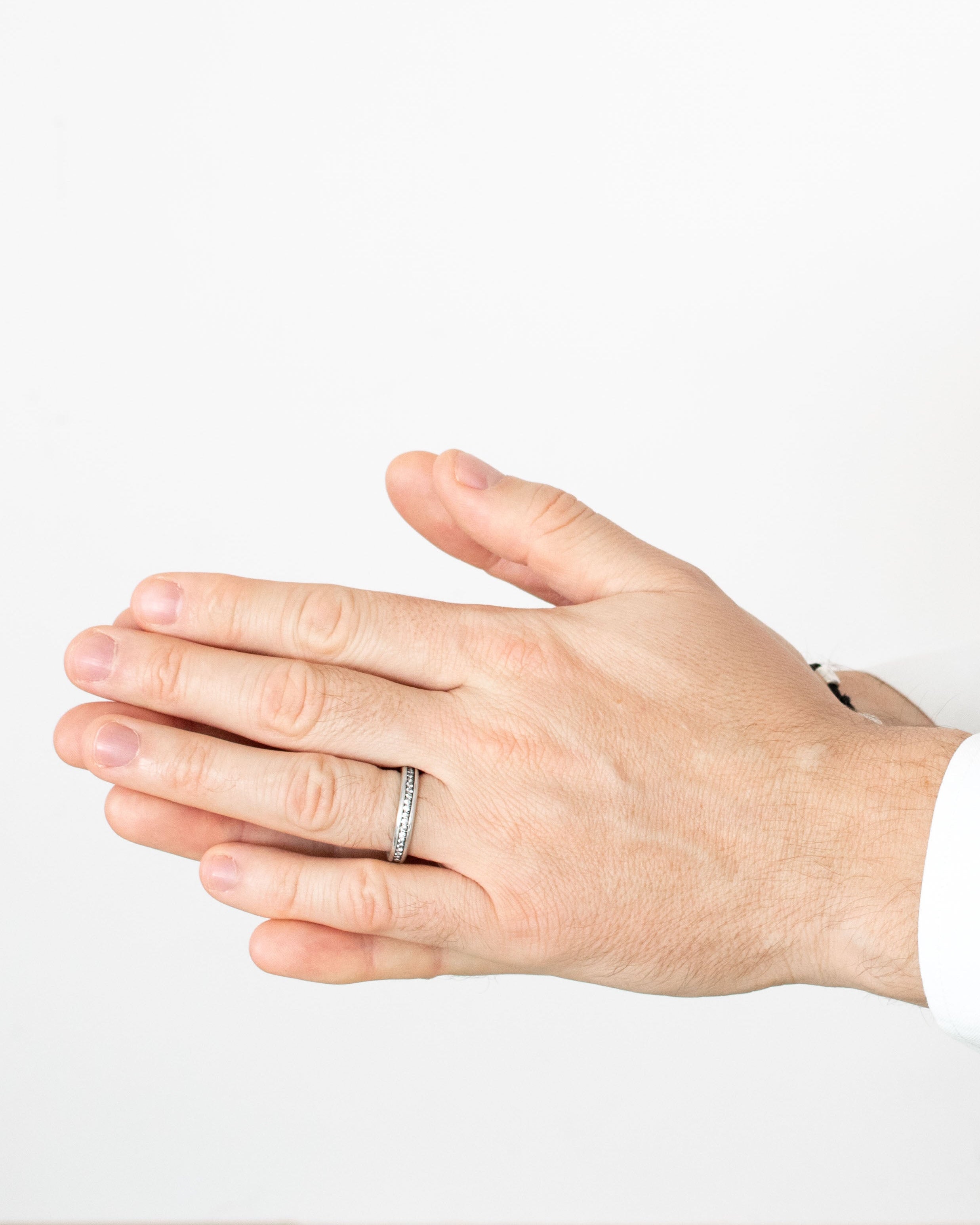 Hand wearing a ring on a white background