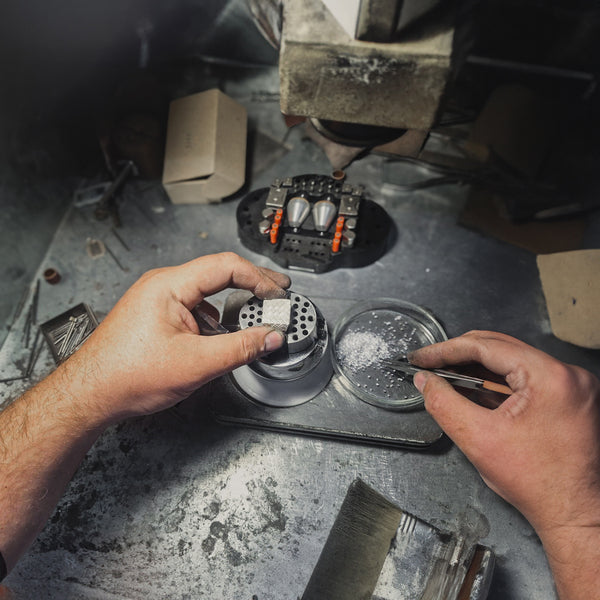 STRONZEN workshop. Our jeweler sets each stone by hand while crafting a large square signet ring.