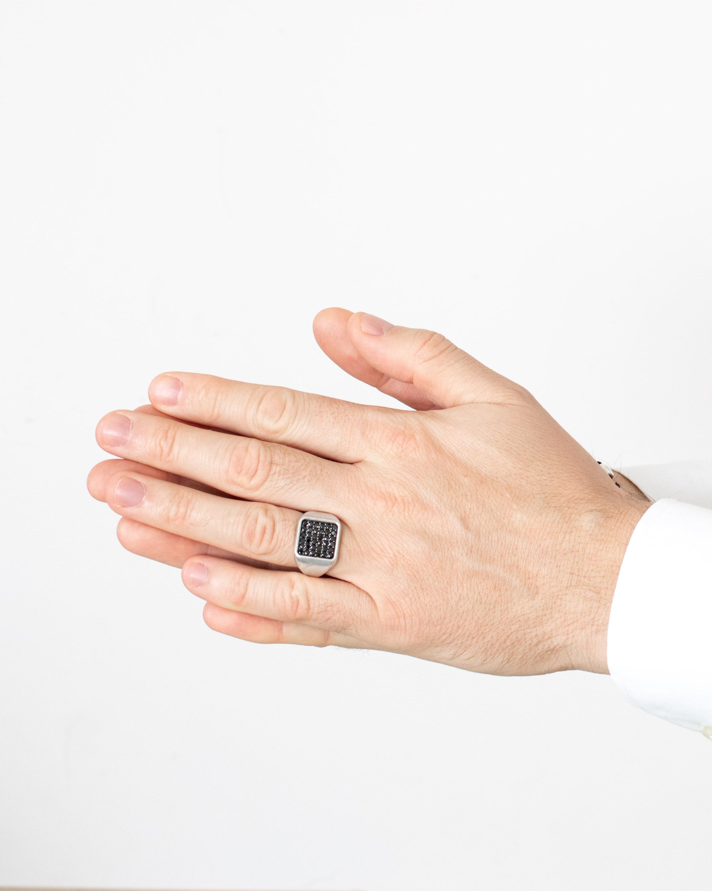 Hand wearing a ring with a white background