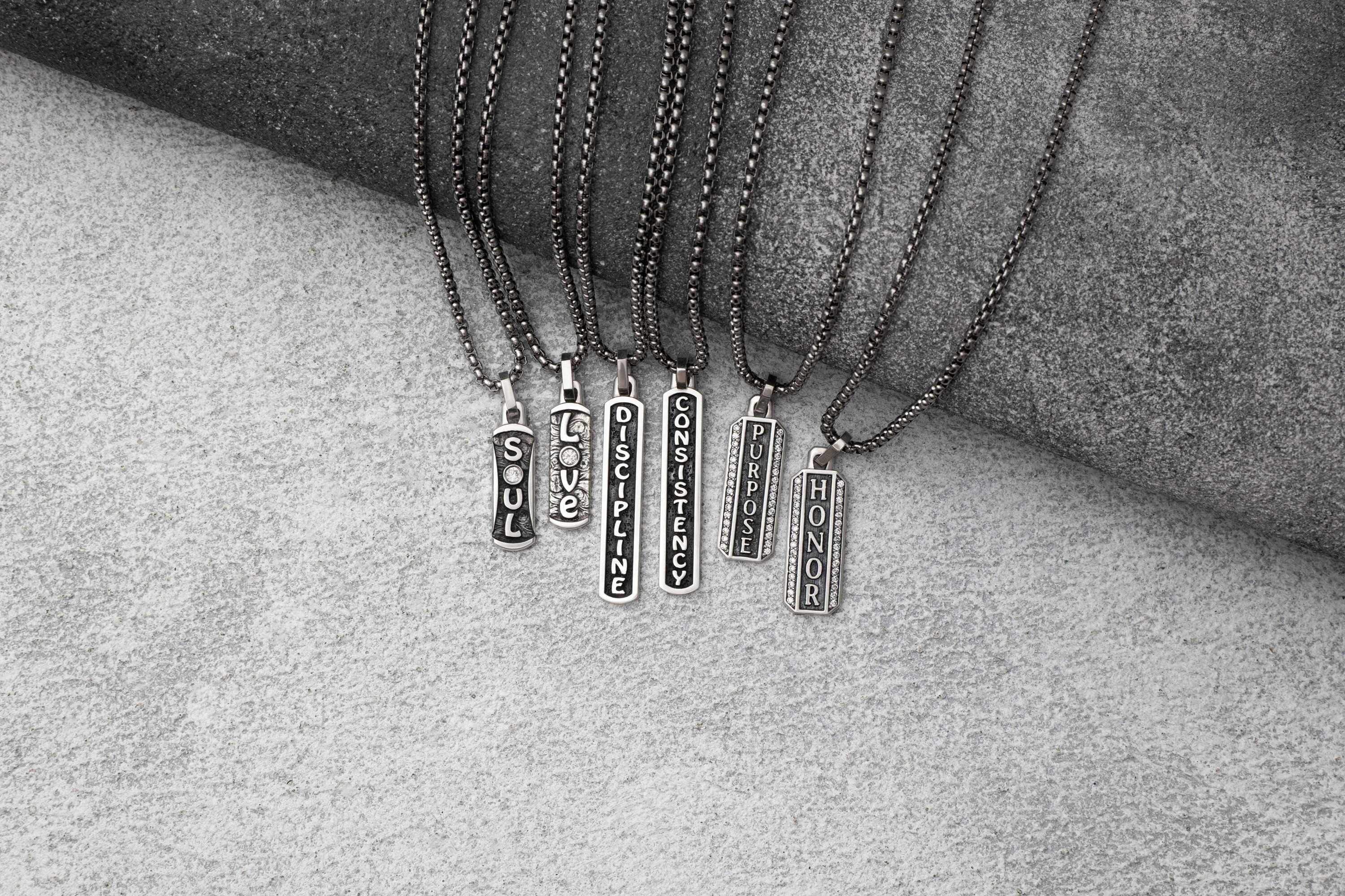 Set of necklaces with pendant tags on a textured surface