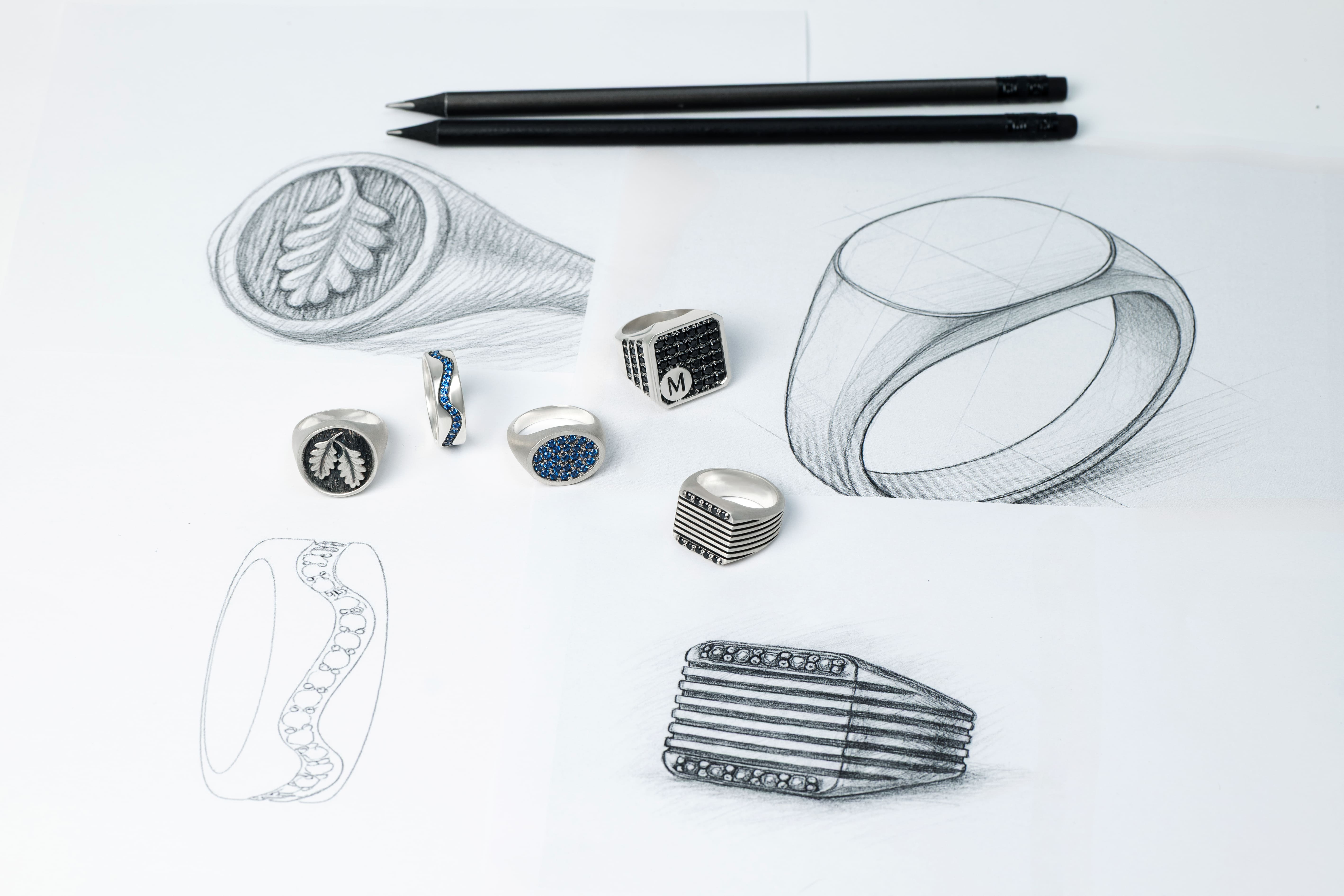 Stronzen rings on a paper with precise design sketches. From concept to creation in solid silver.