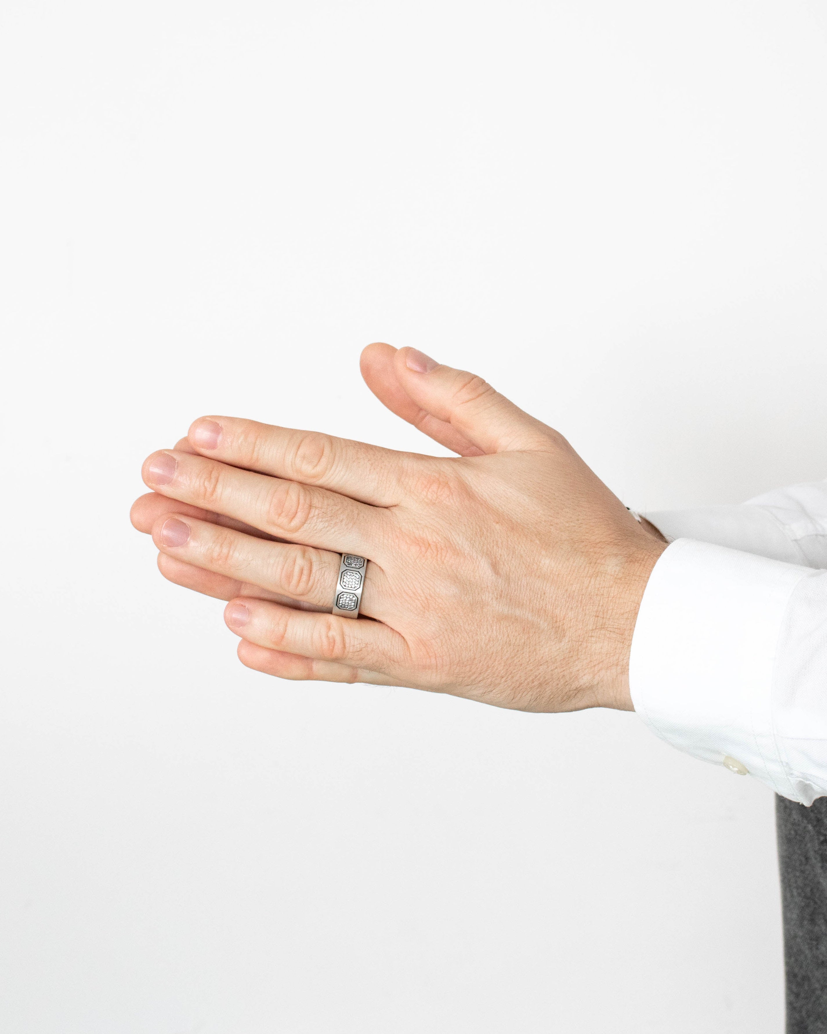 Hand wearing a ring on a white background