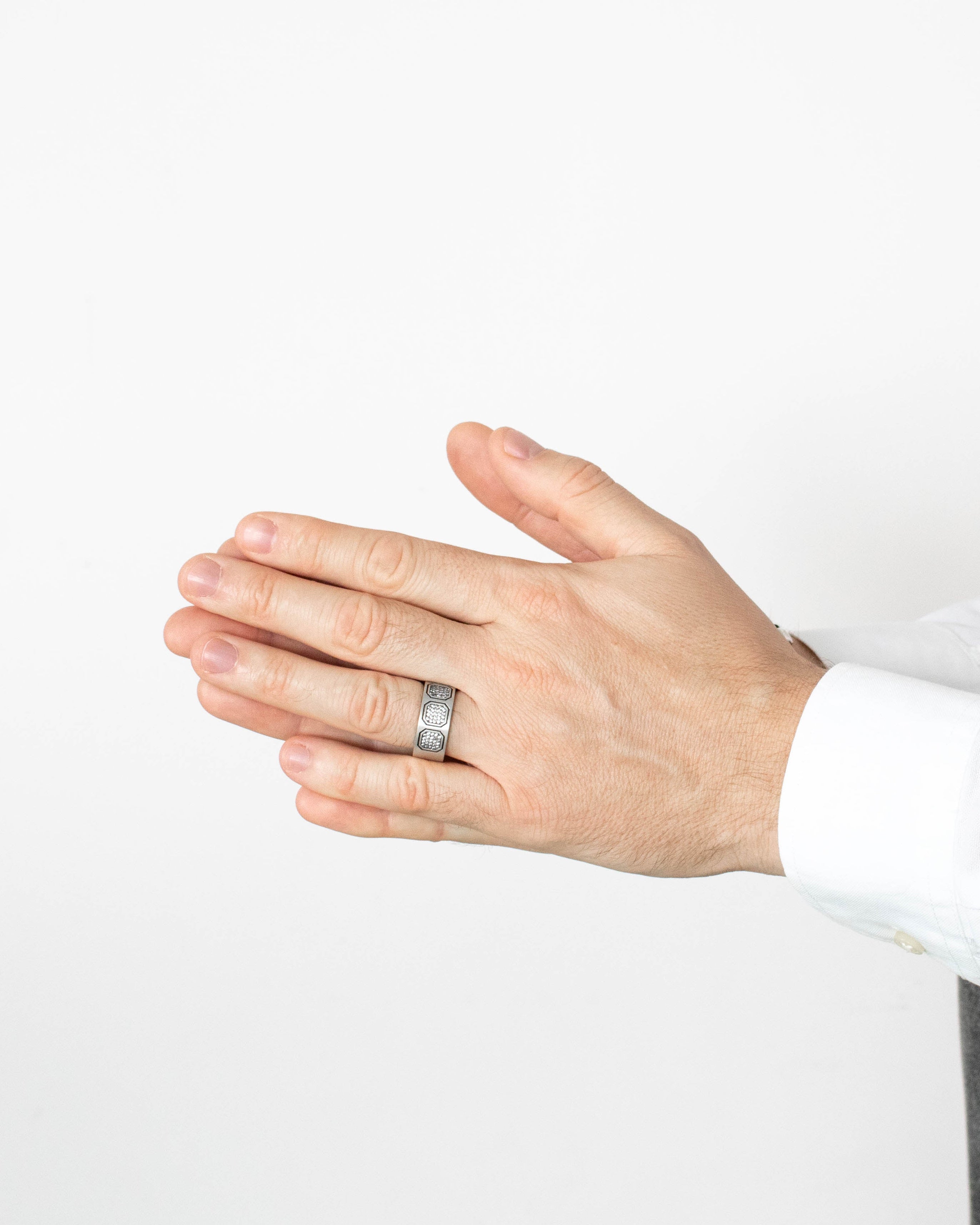Hand wearing a ring on a white background