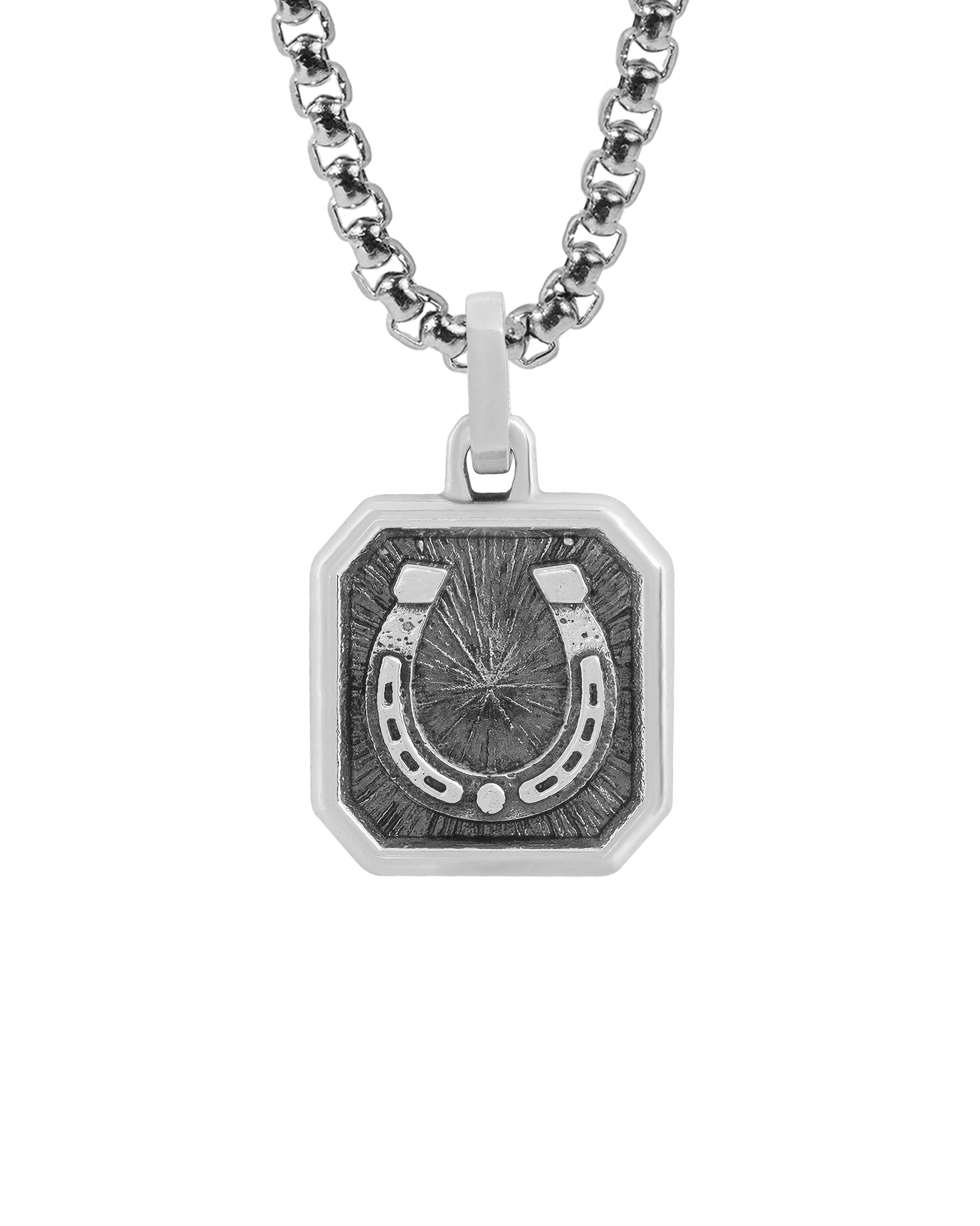 Silver amulet necklace with horseshoe. The piece made in octagon-like soft square shape. The texture is mixed: oxidized and shiny. 